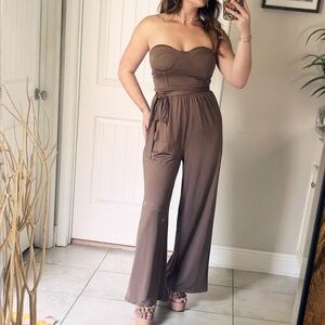 Never worn Romper with adjustable straps and built in padding.